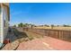Backyard featuring a grassy area, a stone patio and a wooden fence at 47341 Lily Ave, Bennett, CO 80102