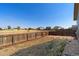 Backyard featuring a grassy area, a stone patio and a wooden fence at 47341 Lily Ave, Bennett, CO 80102