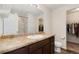 Bathroom with large mirror over vanity, with a walk in shower, and an adjacent closet space at 47341 Lily Ave, Bennett, CO 80102
