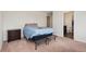 Bedroom with carpet floors, neutral colors and a view into the ensuite bath at 47341 Lily Ave, Bennett, CO 80102