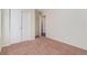 Carpeted room featuring double bi-fold closet doors, and neutral walls at 47341 Lily Ave, Bennett, CO 80102