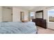 Bedroom featuring carpet, a dresser with a mirror, and large windows at 47341 Lily Ave, Bennett, CO 80102