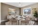 Elegant dining room with stylish decor, a modern light fixture, and a large window at 47341 Lily Ave, Bennett, CO 80102