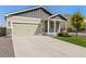 Inviting home featuring a spacious driveway, two-car garage and stone accents on the exterior at 47341 Lily Ave, Bennett, CO 80102