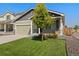 Charming home with a well-manicured lawn, two-car garage, and a mix of stone and siding accents at 47341 Lily Ave, Bennett, CO 80102