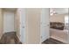 Hallway with hard surface floors and a view into the living room at 47341 Lily Ave, Bennett, CO 80102