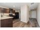 Kitchen with dark brown cabinets, stainless steel appliances and vinyl plank flooring at 47341 Lily Ave, Bennett, CO 80102