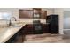 A kitchen featuring dark brown cabinets, a gas stove, and stainless steel appliances at 47341 Lily Ave, Bennett, CO 80102