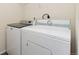 Laundry area featuring a white washing machine and dryer at 47341 Lily Ave, Bennett, CO 80102