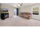 Cozy living room with carpet floors, ceiling fan, and sliding glass doors at 47341 Lily Ave, Bennett, CO 80102