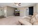 A living room with a TV, carpet, neutral colors, and sliding glass doors at 47341 Lily Ave, Bennett, CO 80102
