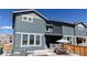 Back of the home showing the backyard patio, with comfortable seating and dining area, and fenced yard at 9095 Birch Run Ln, Parker, CO 80134