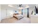 This main bedroom has a ceiling fan, a neutral color scheme, and an ensuite bathroom at 9095 Birch Run Ln, Parker, CO 80134
