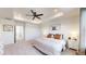 Spacious main bedroom featuring tray ceiling, fan, and neutral décor at 9095 Birch Run Ln, Parker, CO 80134