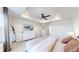 A look at the main bedroom showing the tray ceiling, ceiling fan, and dresser with TV at 9095 Birch Run Ln, Parker, CO 80134