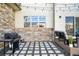 Charming back patio with grill, outdoor seating, and attractive stone and concrete design at 6780 Meade Cir # B, Westminster, CO 80030