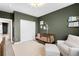 Cozy Bedroom with green walls, a crib, a glider and natural light at 6780 Meade Cir # B, Westminster, CO 80030