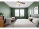 Bedroom with green walls, a ceiling fan, and a white desk by two windows at 6780 Meade Cir # B, Westminster, CO 80030