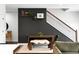 Dining area with a dark accent wall and stairs to the second level at 6780 Meade Cir # B, Westminster, CO 80030