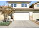 Two-story home with a neutral facade, attached garage, and manicured landscaping at 6780 Meade Cir # B, Westminster, CO 80030