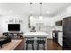 Modern living room open to the kitchen with a white island at 6780 Meade Cir # B, Westminster, CO 80030