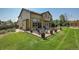 Large backyard features a paver patio, outdoor seating areas, well-maintained lawn and mature trees at 6769 W 70Th Ave, Arvada, CO 80003