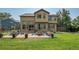 Expansive backyard with a paver patio, dining area, well-maintained lawn, mature trees, and charming landscaping at 6769 W 70Th Ave, Arvada, CO 80003