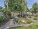 Backyard garden featuring a charming fountain surrounded by vibrant plants and lush greenery at 6769 W 70Th Ave, Arvada, CO 80003