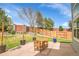 Paver patio with an outdoor dining area, beautiful landscaping, mature trees and a privacy fence at 6769 W 70Th Ave, Arvada, CO 80003