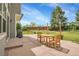 Backyard with paver patio with outdoor dining area, a well-maintained lawn, mature trees and privacy fencing at 6769 W 70Th Ave, Arvada, CO 80003