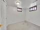 Finished basement room with carpet, white walls, light fixtures, and small windows at 6769 W 70Th Ave, Arvada, CO 80003