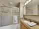 This bathroom features a shower with sliding glass doors, vanity with granite counters, and a framed mirror at 6769 W 70Th Ave, Arvada, CO 80003