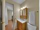 This bathroom features a vanity, updated fixtures, and a view into the bedroom at 6769 W 70Th Ave, Arvada, CO 80003