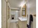 Bathroom with vanity, mirror, shower with glass doors, and built in cabinet with glass doors for storage at 6769 W 70Th Ave, Arvada, CO 80003