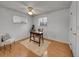 Minimalist bedroom with light hardwood floors, neutral walls, and large windows at 6769 W 70Th Ave, Arvada, CO 80003