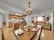 Inviting dining area with hardwood floors, chandelier, and open layout flowing into the kitchen and living room at 6769 W 70Th Ave, Arvada, CO 80003