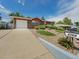 Charming brick home with landscaped front yard, lush greenery and a well-maintained lawn at 6769 W 70Th Ave, Arvada, CO 80003