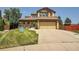 Charming two-story home with a spacious front lawn and a two-car garage and covered porch at 6769 W 70Th Ave, Arvada, CO 80003