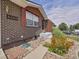 Close-up of a brick home's entry showcasing stone landscaping and a cozy, inviting entrance at 6769 W 70Th Ave, Arvada, CO 80003