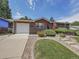 Charming home featuring a brick facade, well-manicured lawn, and inviting landscaping at 6769 W 70Th Ave, Arvada, CO 80003