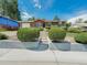 Charming brick ranch with manicured lawn and mature landscaping creating curb appeal at 6769 W 70Th Ave, Arvada, CO 80003
