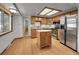 Bright kitchen featuring stainless steel appliances, granite countertops, and central island at 6769 W 70Th Ave, Arvada, CO 80003