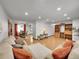 Open-concept living room featuring stylish furnishings, wood floors, and seamless flow to dining area at 6769 W 70Th Ave, Arvada, CO 80003