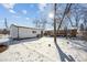 Detached garage and expansive backyard with snow at 3345 W Aqueduct Ave, Littleton, CO 80123