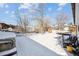 Spacious backyard with snow, hot tub, trampoline, and trees at 3345 W Aqueduct Ave, Littleton, CO 80123