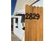 Close-up of address on wooden fence, showcasing the property's street number in a clear, visible manner at 2829 W College Ave, Denver, CO 80219