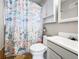 Bathroom with tiled floors, a seashell-themed shower curtain, and a white vanity at 2829 W College Ave, Denver, CO 80219