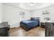 Bedroom features wood-look floors, natural light, and modern rustic furniture at 2829 W College Ave, Denver, CO 80219