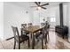 Bright dining room featuring tile floors, a ceiling fan, and a cozy wood burning stove at 2829 W College Ave, Denver, CO 80219