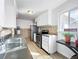 Kitchen featuring tiled backsplash, stainless steel appliances, and ample cabinet space at 2829 W College Ave, Denver, CO 80219